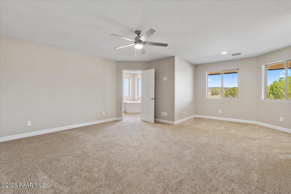1220 East Cougar Ridge Road Paulden, AZ 86334 - Photo 14 of 30 an empty room with windows and fan