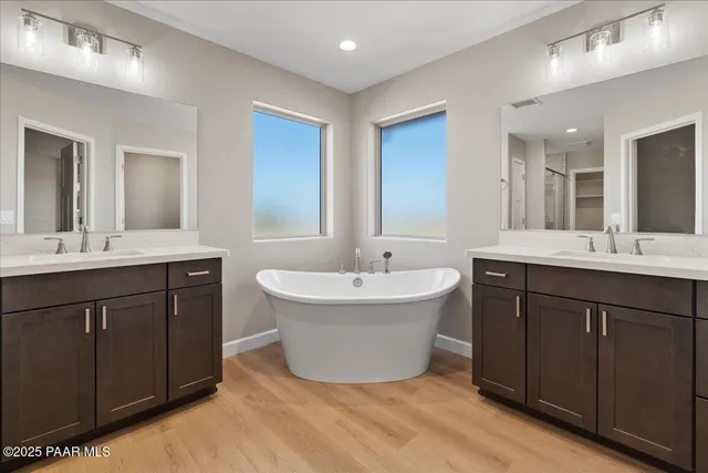 a spacious bathroom with a double vanity sink mirror and double