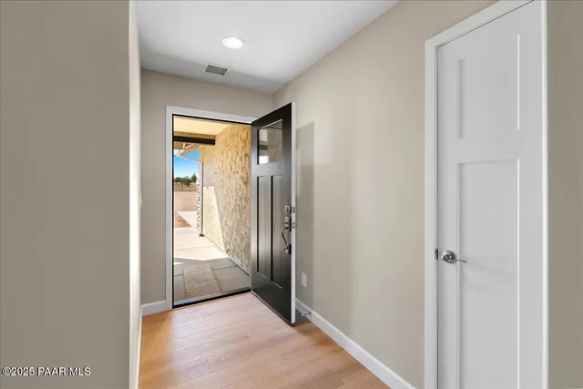 a view of a hallway with wooden floor