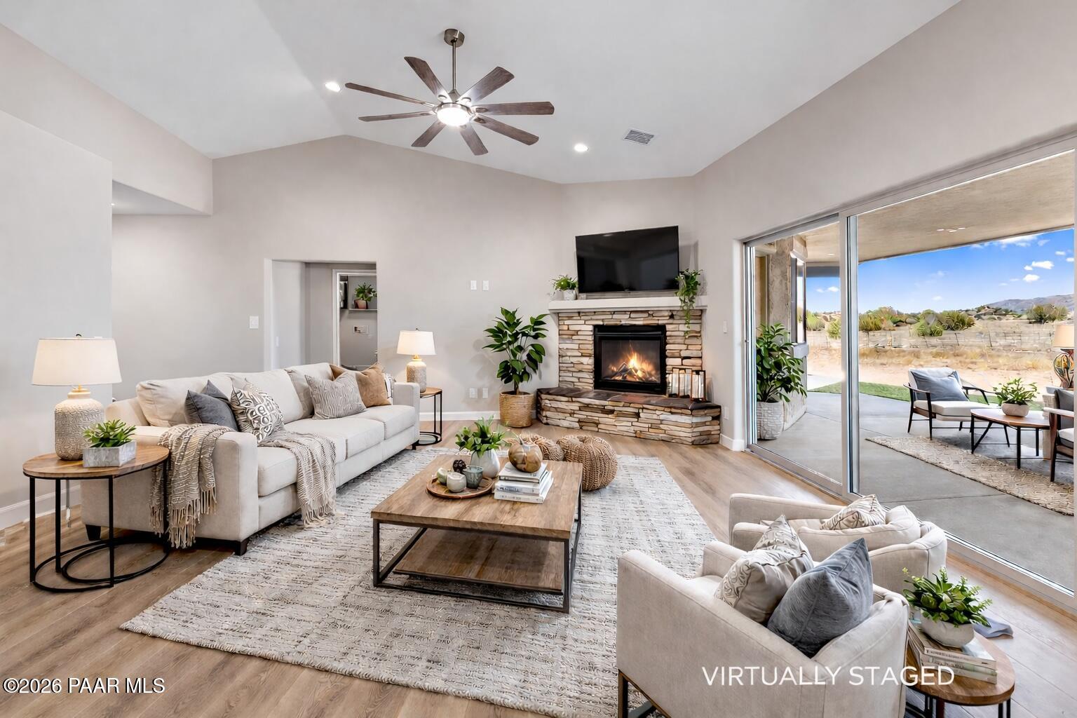 1220 East Cougar Ridge Road Paulden, AZ 86334 - Photo 6 of 30 a living room with furniture a flat screen tv and a fireplace