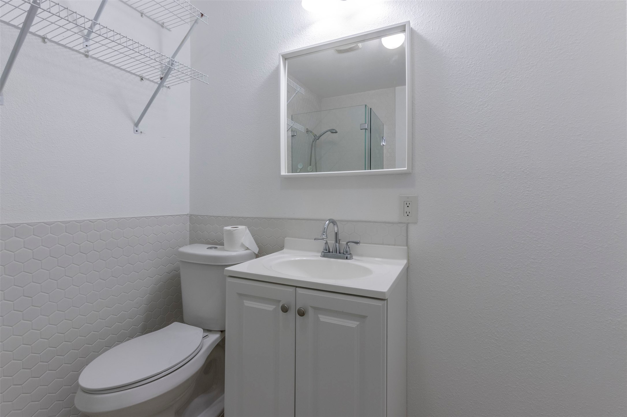 2903 Rogge Lane Austin, TX 78723 - Photo 12 of 26 a bathroom with a toilet a sink and mirror