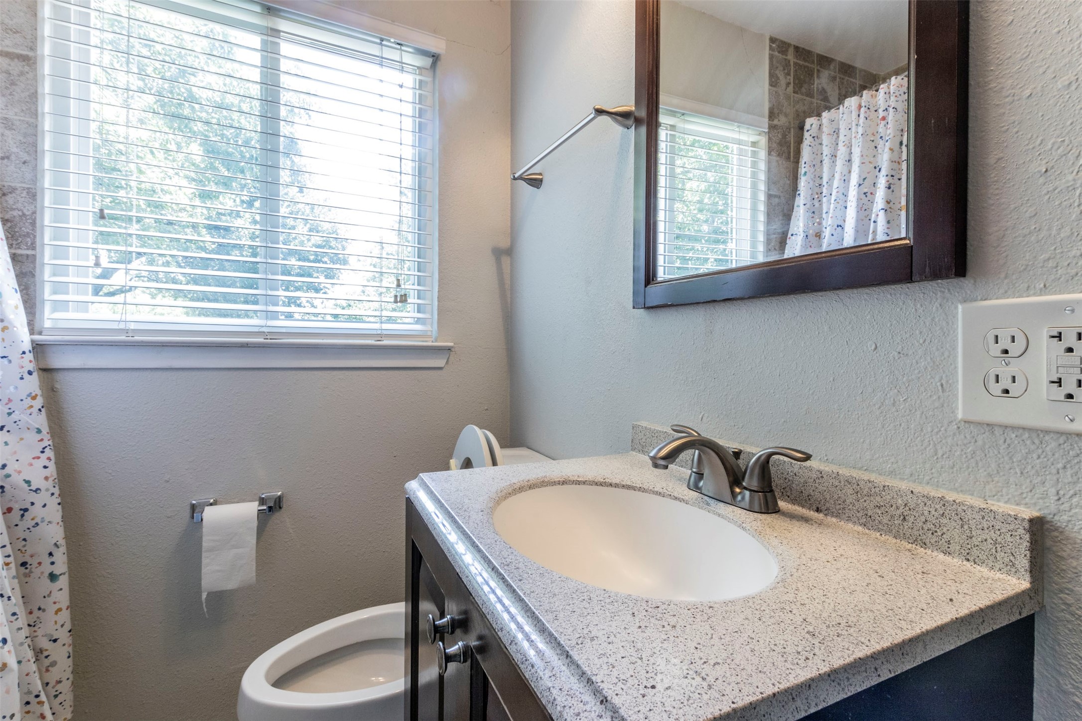 2903 Rogge Lane Austin, TX 78723 - Photo 16 of 26 a bathroom with sink granite and a toilet