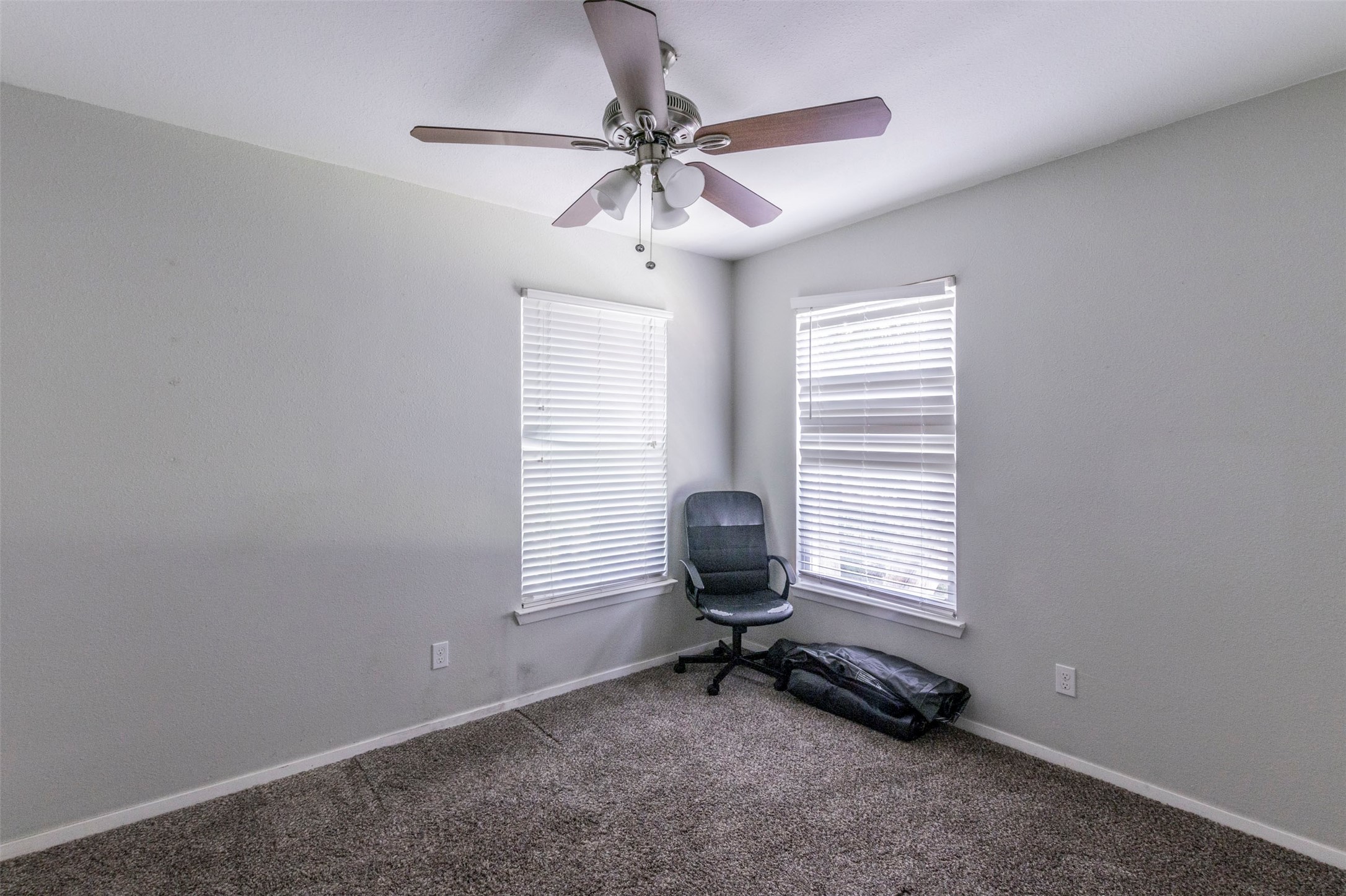 2903 Rogge Lane Austin, TX 78723 - Photo 17 of 26 a room with window a ceiling fan and windows