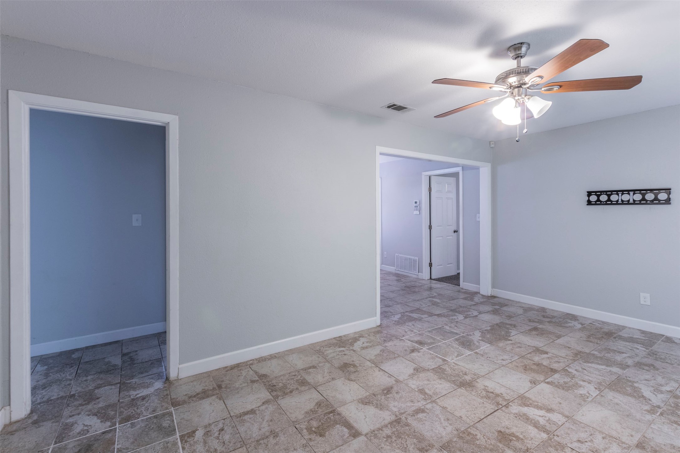 2903 Rogge Lane Austin, TX 78723 - Photo 2 of 26 a view of an empty room with a chandelier fan