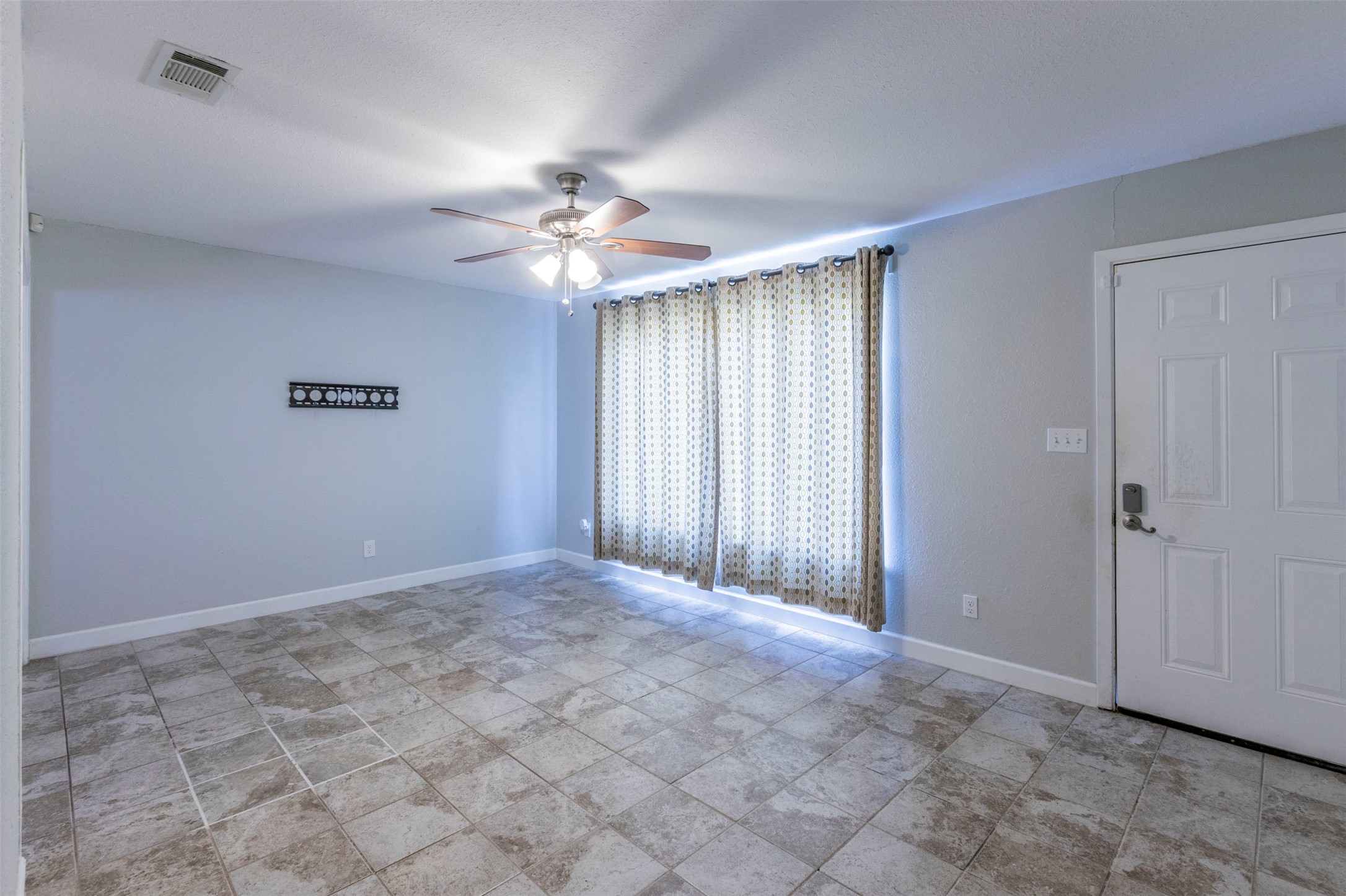 2903 Rogge Lane Austin, TX 78723 - Photo 3 of 26 a view of an empty room with a window