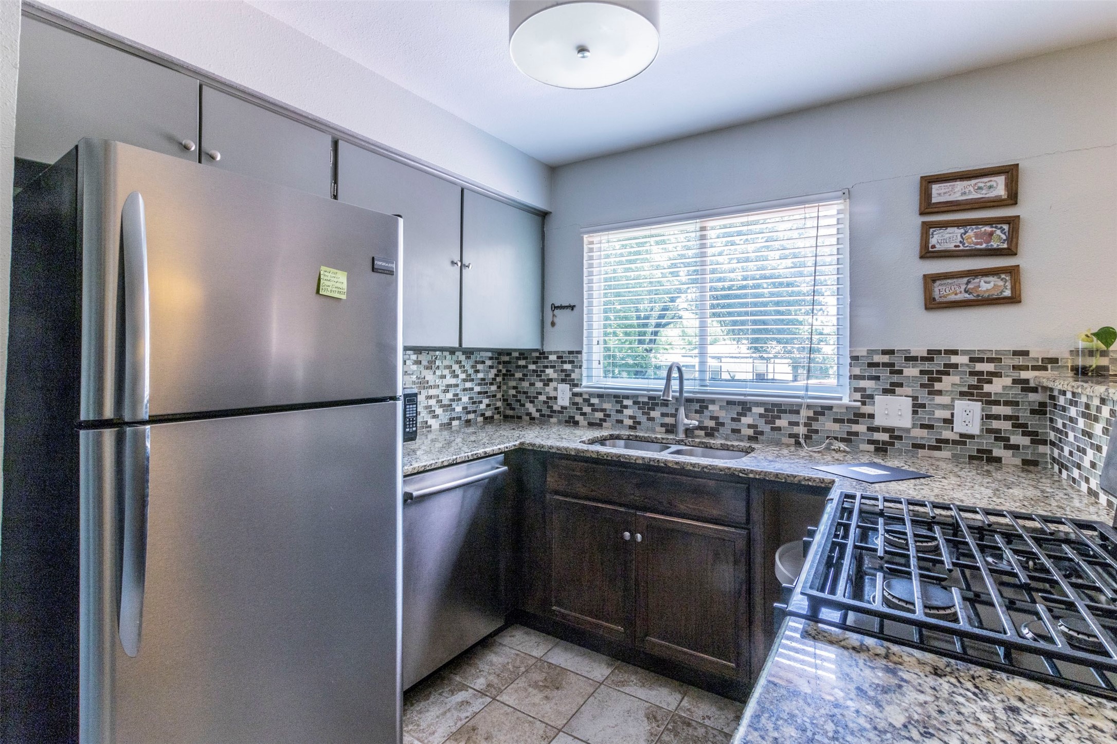 2903 Rogge Lane Austin, TX 78723 - Photo 5 of 26 a kitchen with a refrigerator and a sink