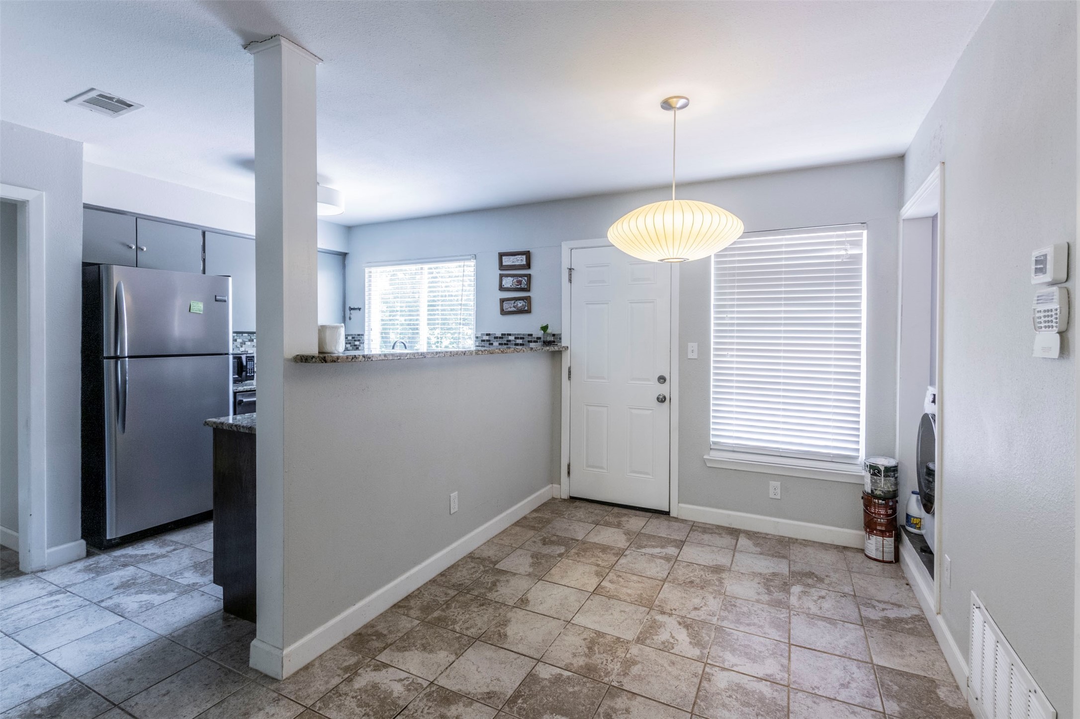 2903 Rogge Lane Austin, TX 78723 - Photo 8 of 26 a bathroom with a refrigerator and a sink