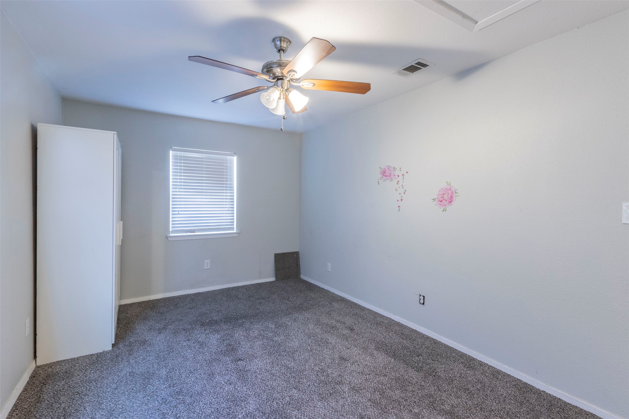2903 Rogge Lane Austin, TX 78723 - Photo 10 of 26 an empty room with windows and fan
