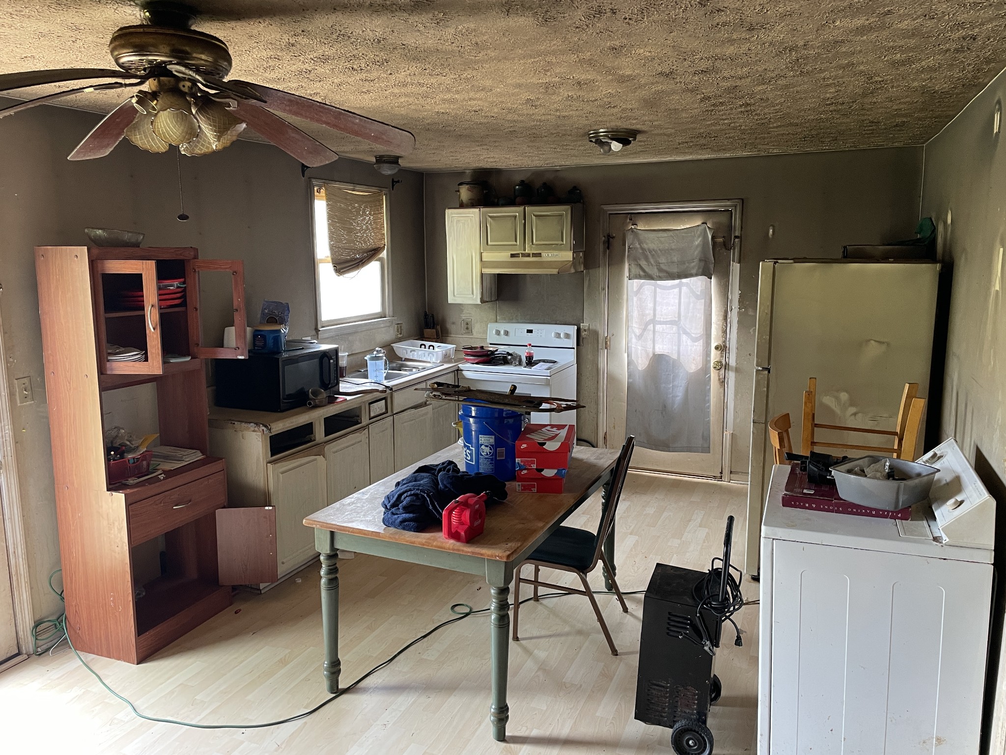 104 Pleasant Drive Smyrna, TN 37167 - Photo 11 of 17 a kitchen with stainless steel appliances kitchen island granite countertop a refrigerator a stove a microwave oven with a dining table and chairs