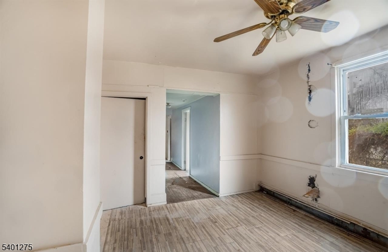 613 South New York Road Absecon, NJ 08205 - Photo 11 of 18 a bedroom with a bed and a chandelier