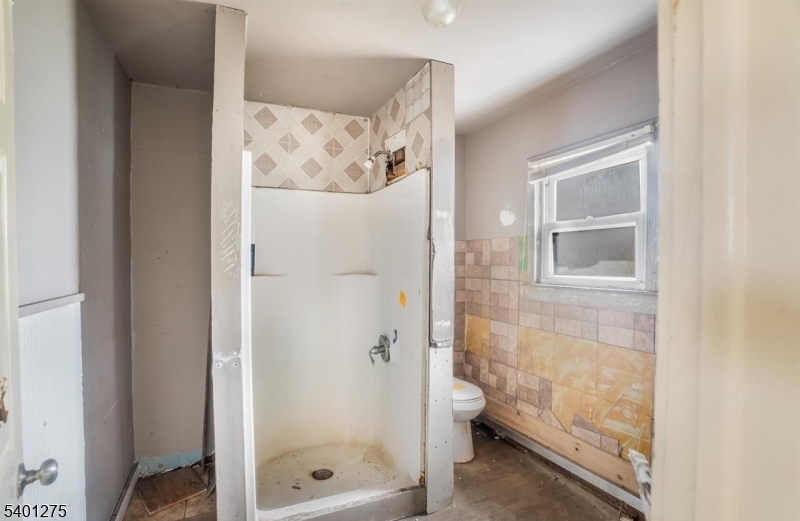 613 South New York Road Absecon, NJ 08205 - Photo 14 of 18 a bathroom with a glass shower door