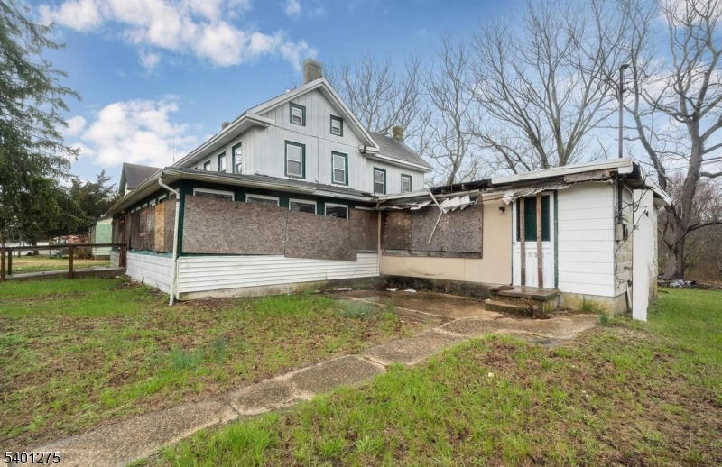 613 South New York Road Absecon, NJ 08205 - Photo 16 of 18 a view of a white house that has a small yard and large trees