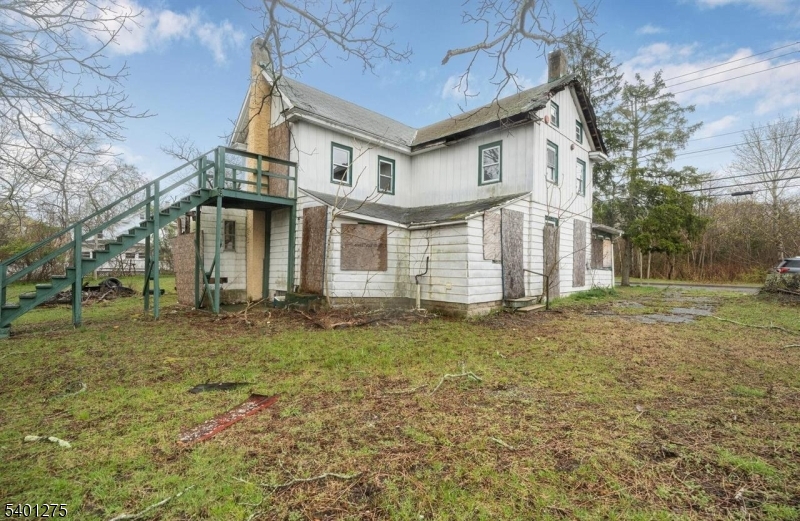 613 South New York Road Absecon, NJ 08205 - Photo 2 of 18 a view of a white house next to a yard with big trees