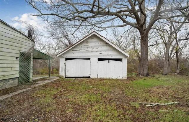 a white house that has a tree in front of it