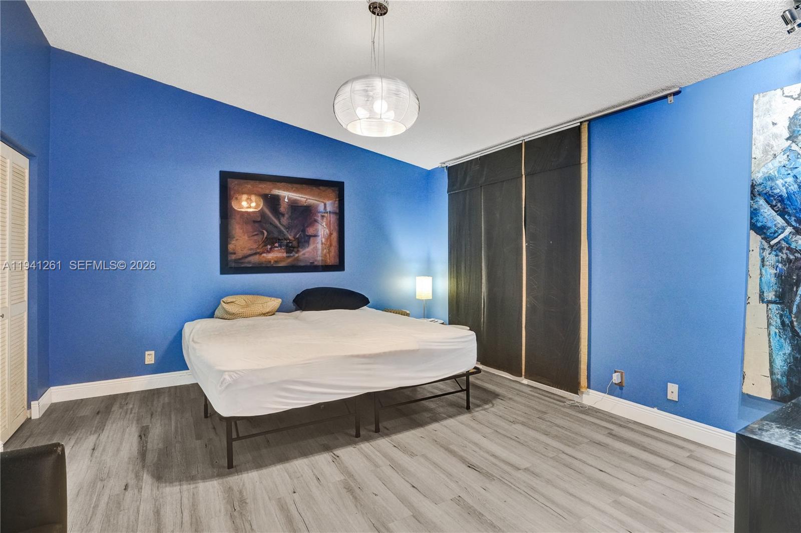 1851 Southwest 116th Way Miramar, FL 33025 - Photo 14 of 30 a bedroom with a bed and a table