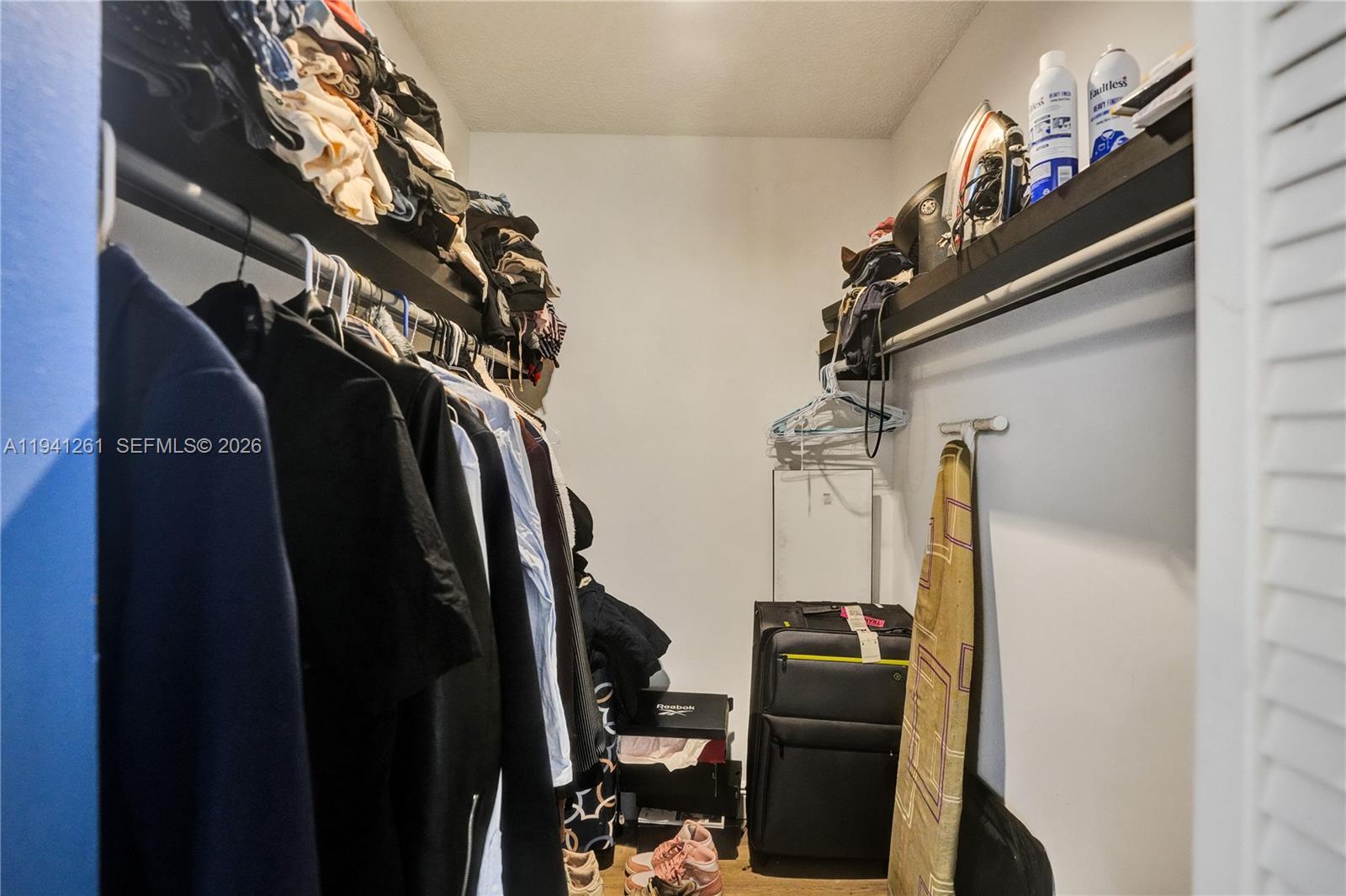 1851 Southwest 116th Way Miramar, FL 33025 - Photo 20 of 30 a view of walk in closet with clothes and shoes