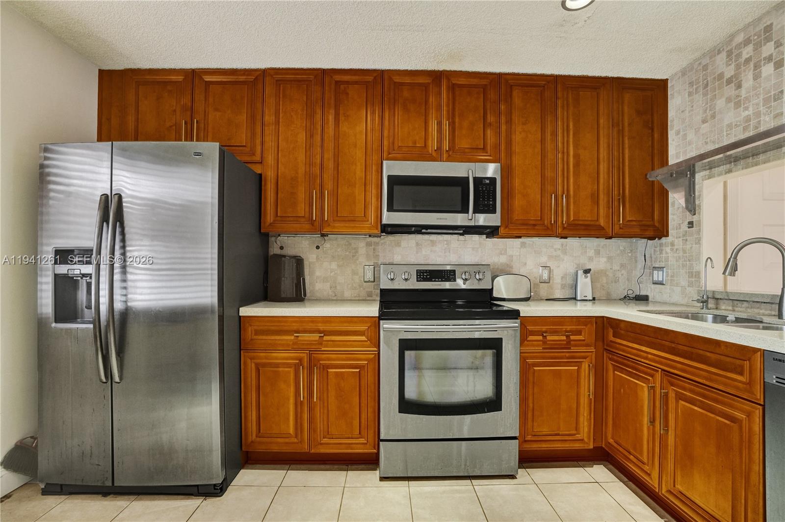 1851 Southwest 116th Way Miramar, FL 33025 - Photo 6 of 30 a kitchen with a refrigerator sink and microwave
