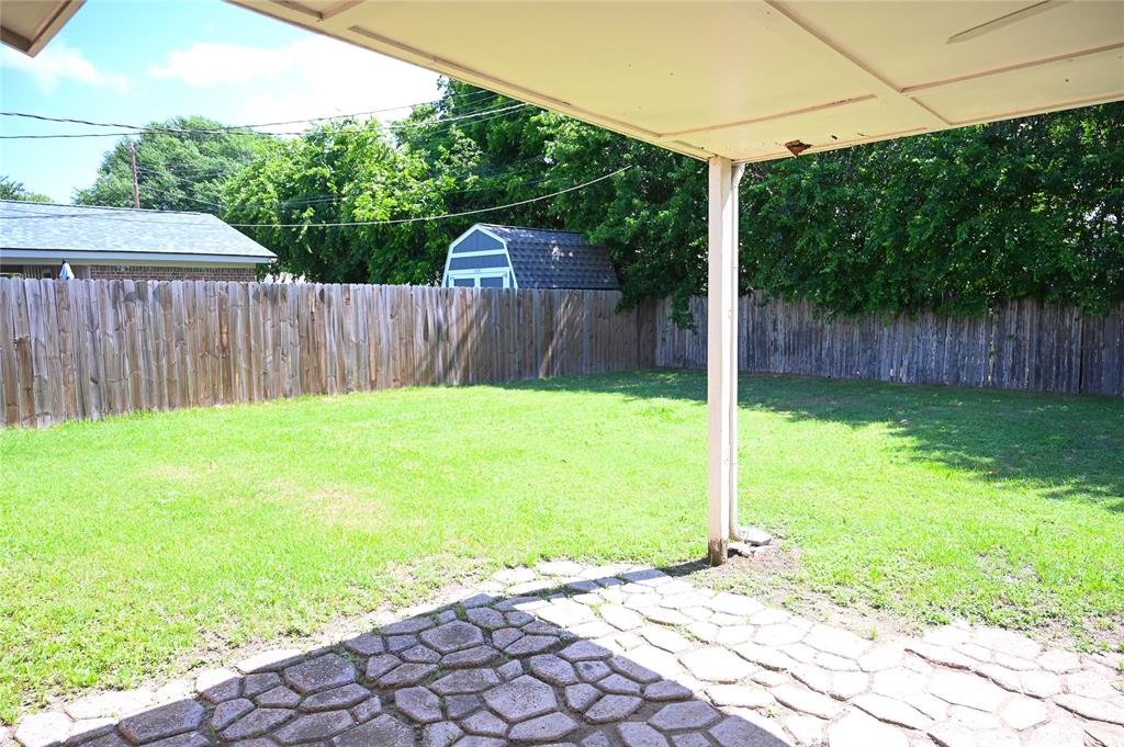 1352 Simpson Drive Hurst, TX 76053 - Photo 19 of 40 Expansive green lawn with a full privacy fence