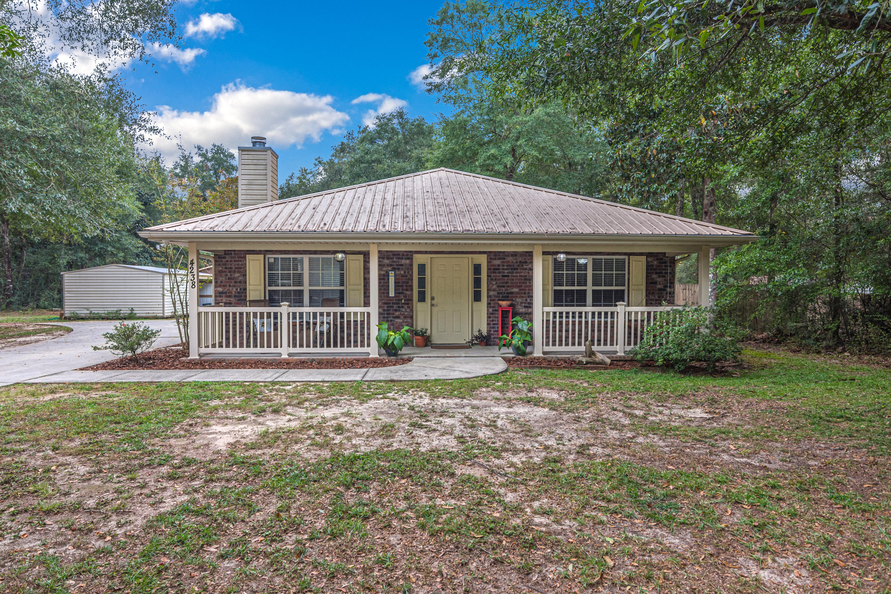 4238 Painter Branch Road Crestview, FL 32539 - Photo 1 of 30 a front view of a house with a garden