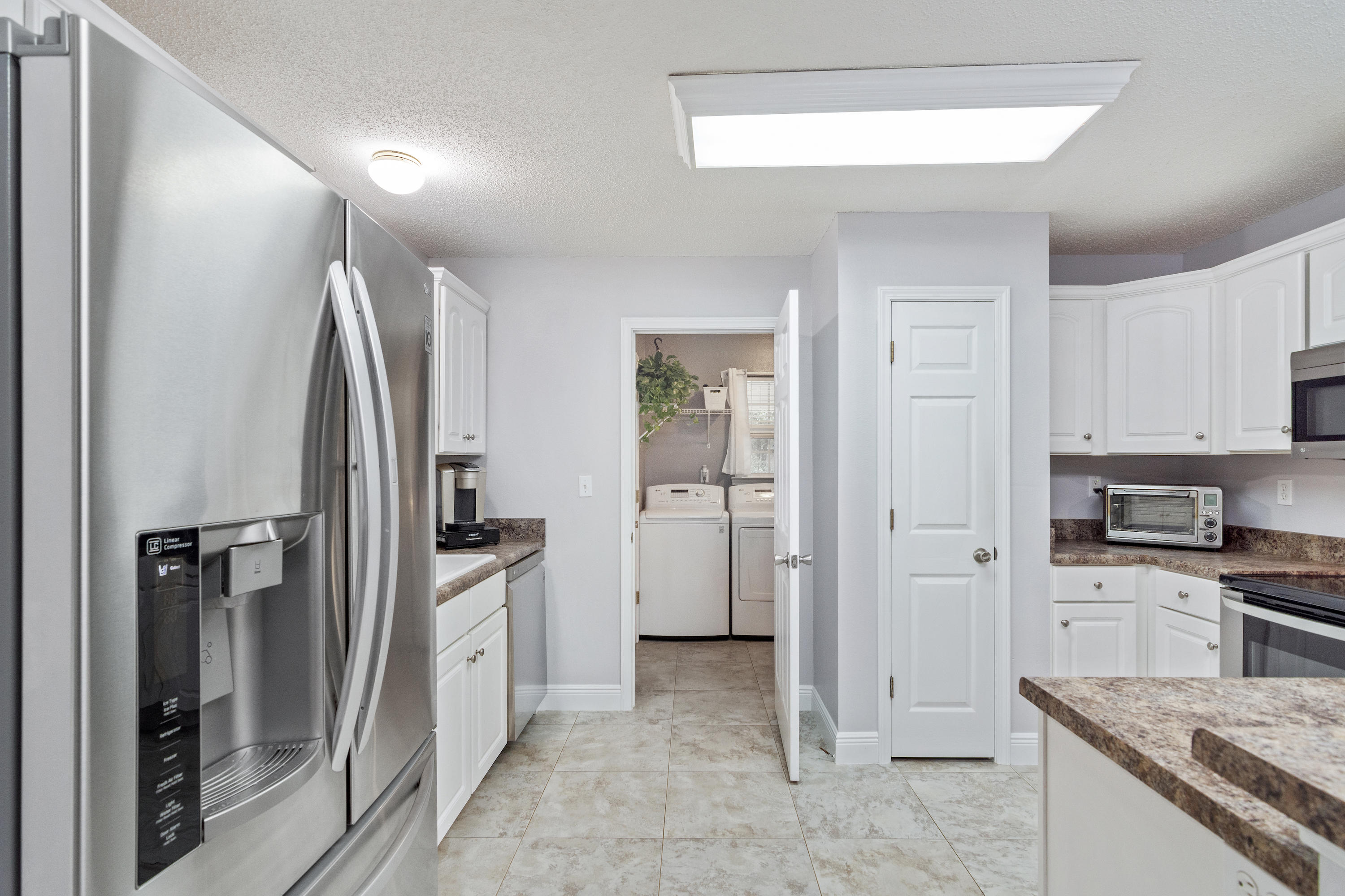 4238 Painter Branch Road Crestview, FL 32539 - Photo 9 of 30 a kitchen with a refrigerator and a sink