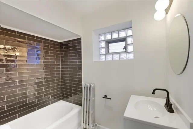 a bathroom with a sink a bathtub and a shower