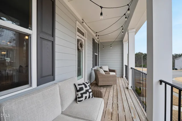 a balcony with wooden floor and furniture
