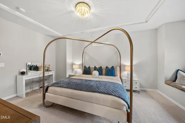 a bedroom with a bed and a potted plant on the dresser