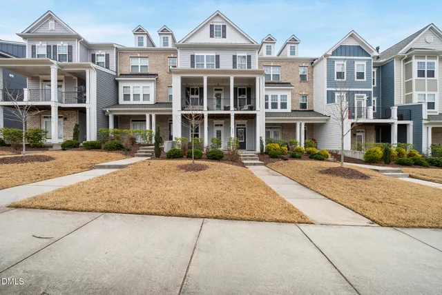 a front view of a residential apartment building with a yard