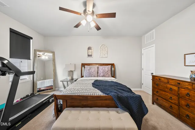 a bedroom with a bed and a dresser