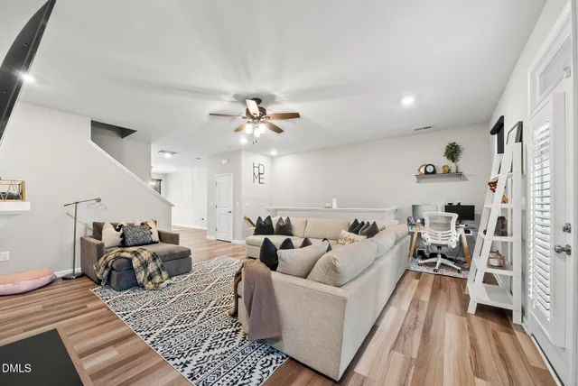 a living room with furniture and wooden floor