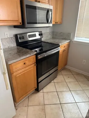 a kitchen with a stove a microwave and a sink