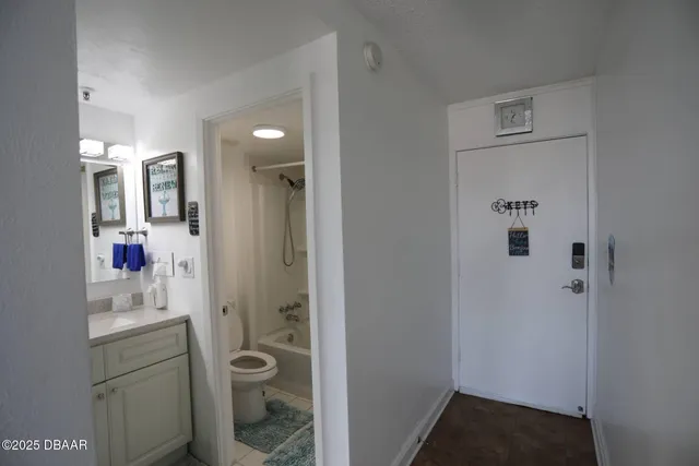 a bathroom with a shower sink and mirror