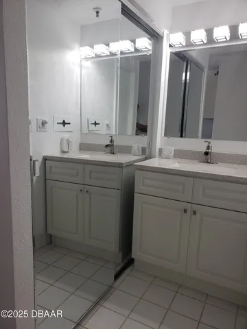 a bathroom with a sink vanity and mirror