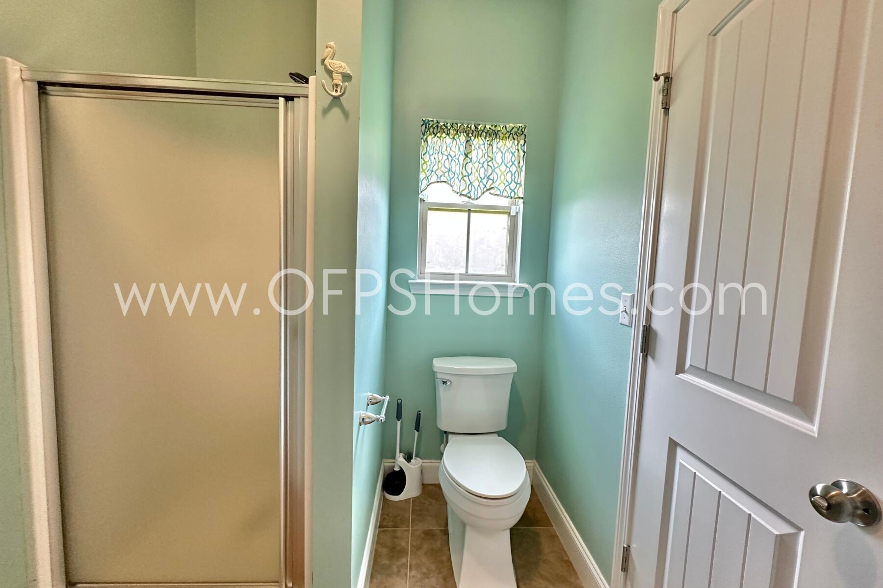 4542 Annabelle Lane Crestview, FL 32539 - Photo 22 of 35 a bathroom with a toilet and a shower