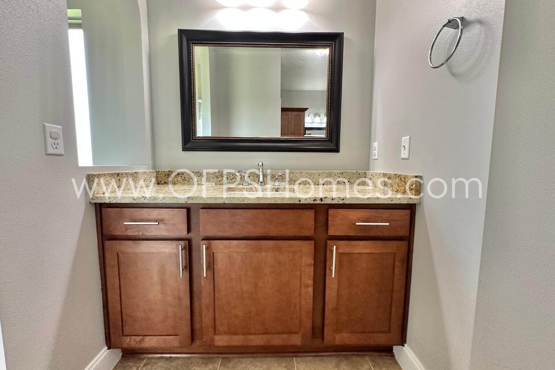 4542 Annabelle Lane Crestview, FL 32539 - Photo 28 of 35 a bathroom with a sink and a mirror