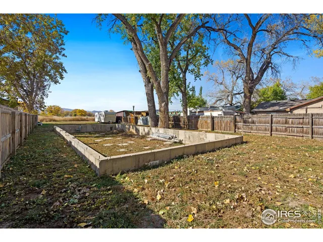 a view of a backyard with a table and chair