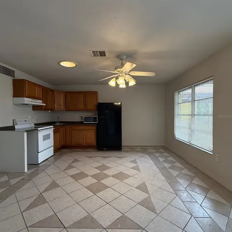 a view of a kitchen with a sink and cabinets