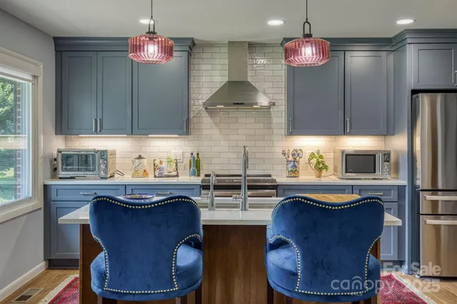 a kitchen with refrigerator a sink and cabinets
