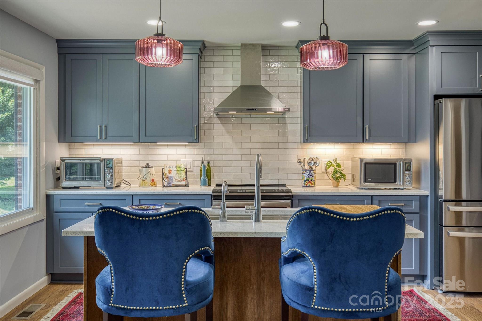 a kitchen with refrigerator a sink and cabinets
