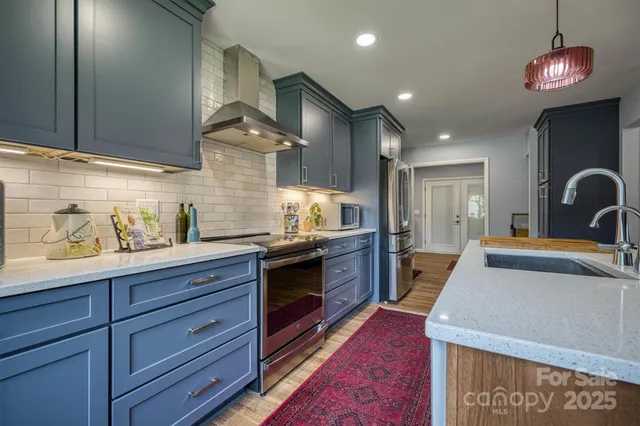 a kitchen with granite countertop wooden cabinets and stainless steel appliances