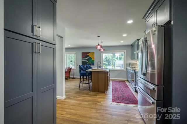 a kitchen view with stainless steel appliances refrigerator stove microwave and cabinets