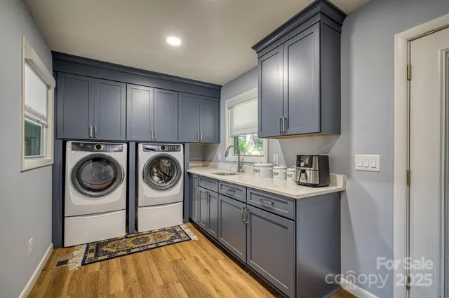 a utility room with sink dryer and washer