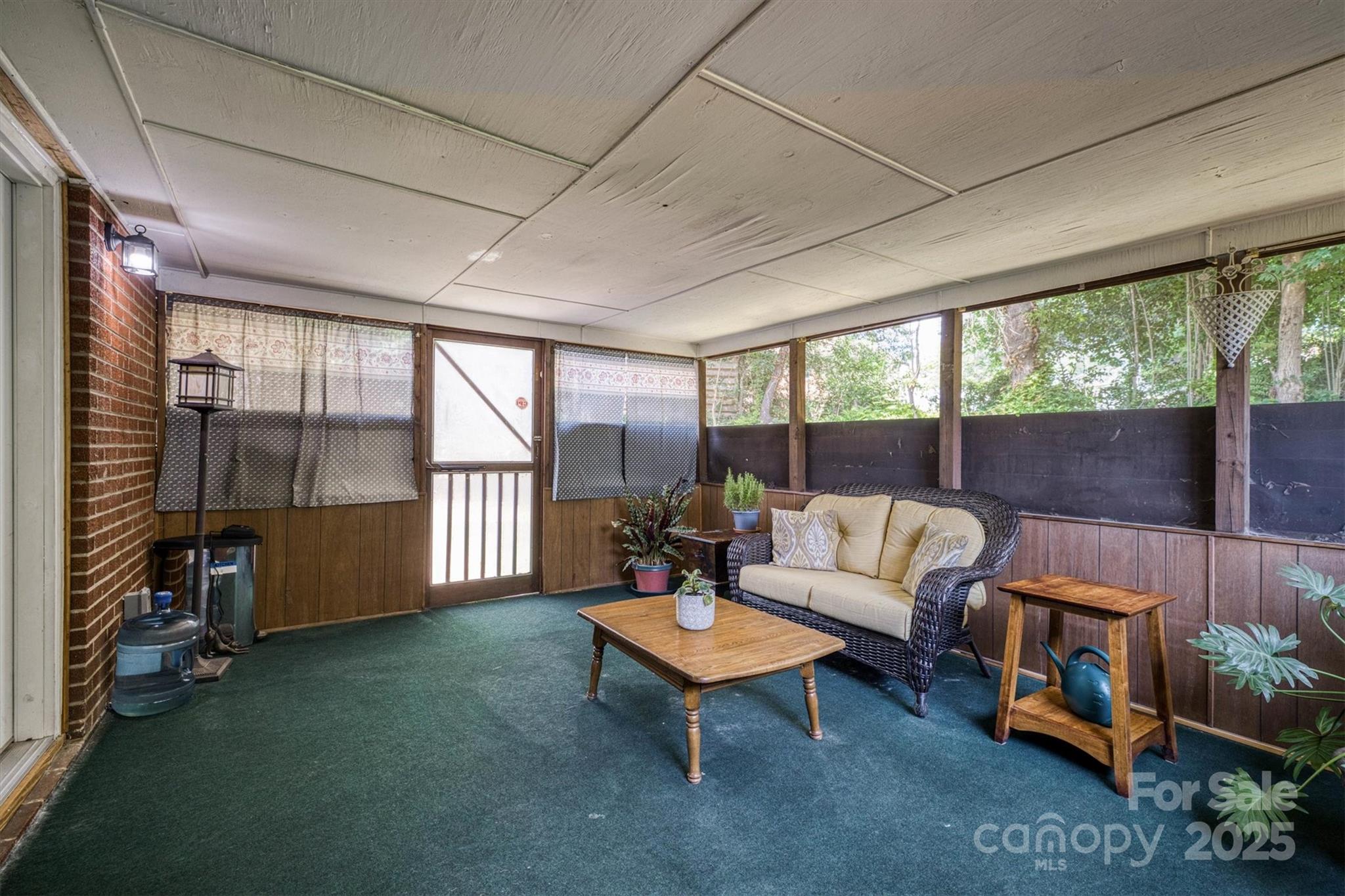 214 Howard Street Morganton, NC 28655 - Photo 16 of 29 a living room with furniture and a floor to ceiling window