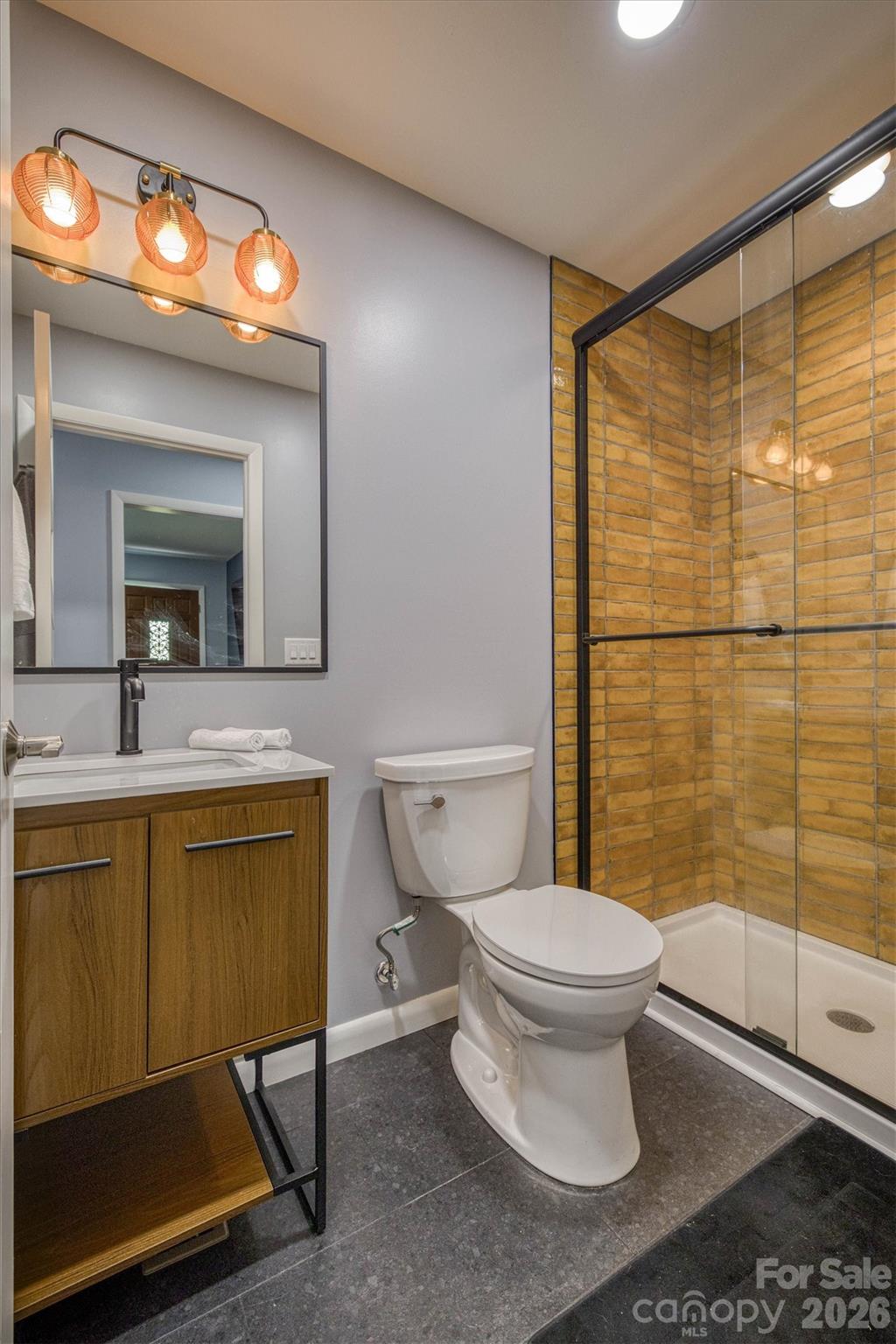214 Howard Street Morganton, NC 28655 - Photo 18 of 22 a bathroom with a sink mirror vanity and toilet