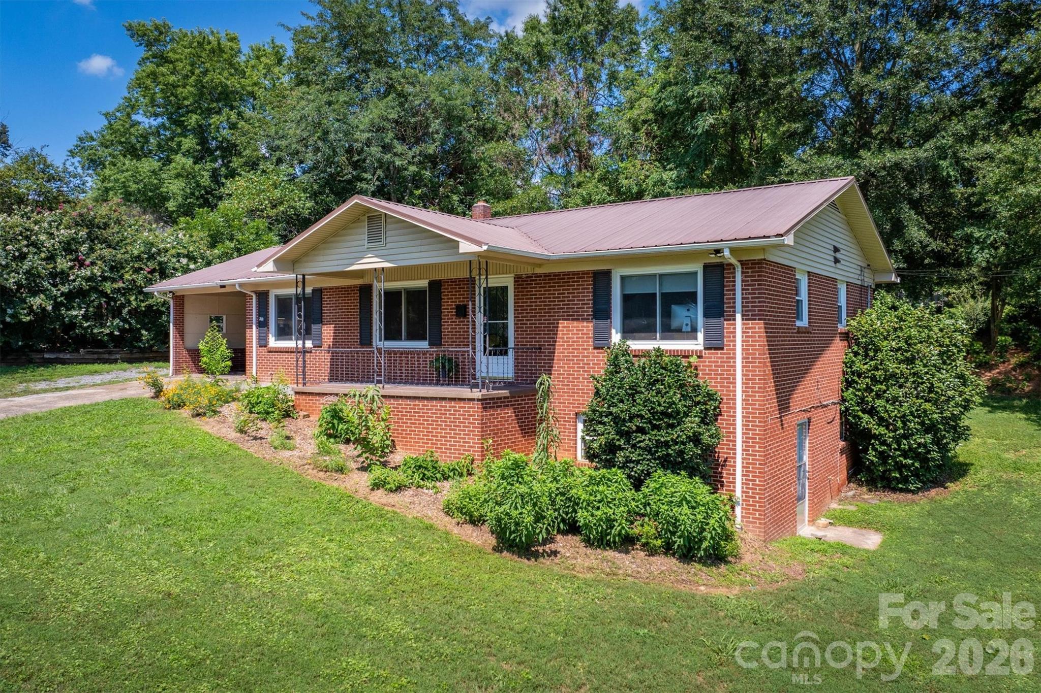 214 Howard Street Morganton, NC 28655 - Photo 3 of 22 a front view of a house with a yard
