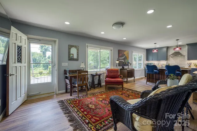 a living room with furniture and a wooden floor