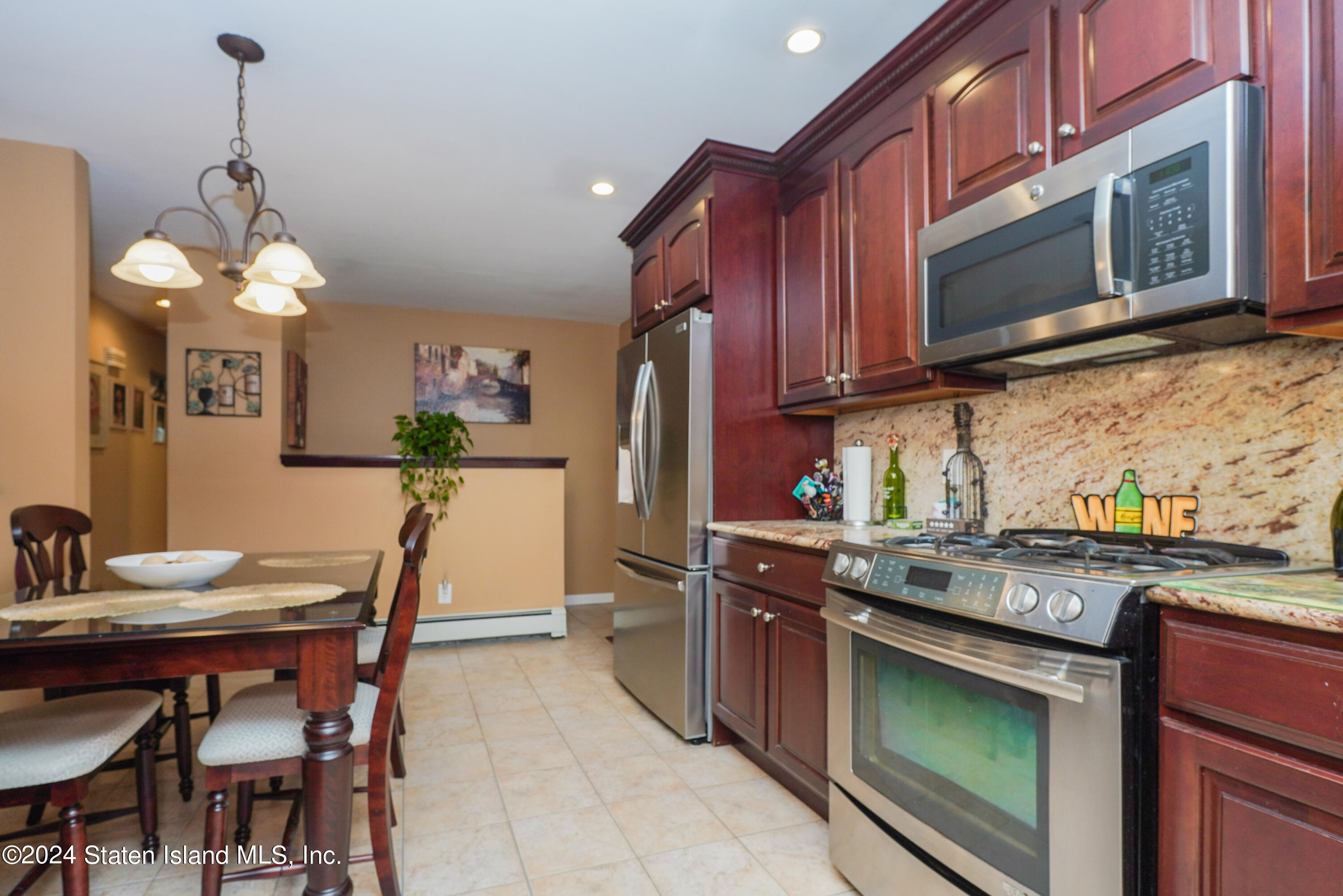 50 Ridgecrest Avenue Staten Island, NY 10312 - Photo 12 of 34 a kitchen with granite countertop wooden cabinets and stainless steel appliances