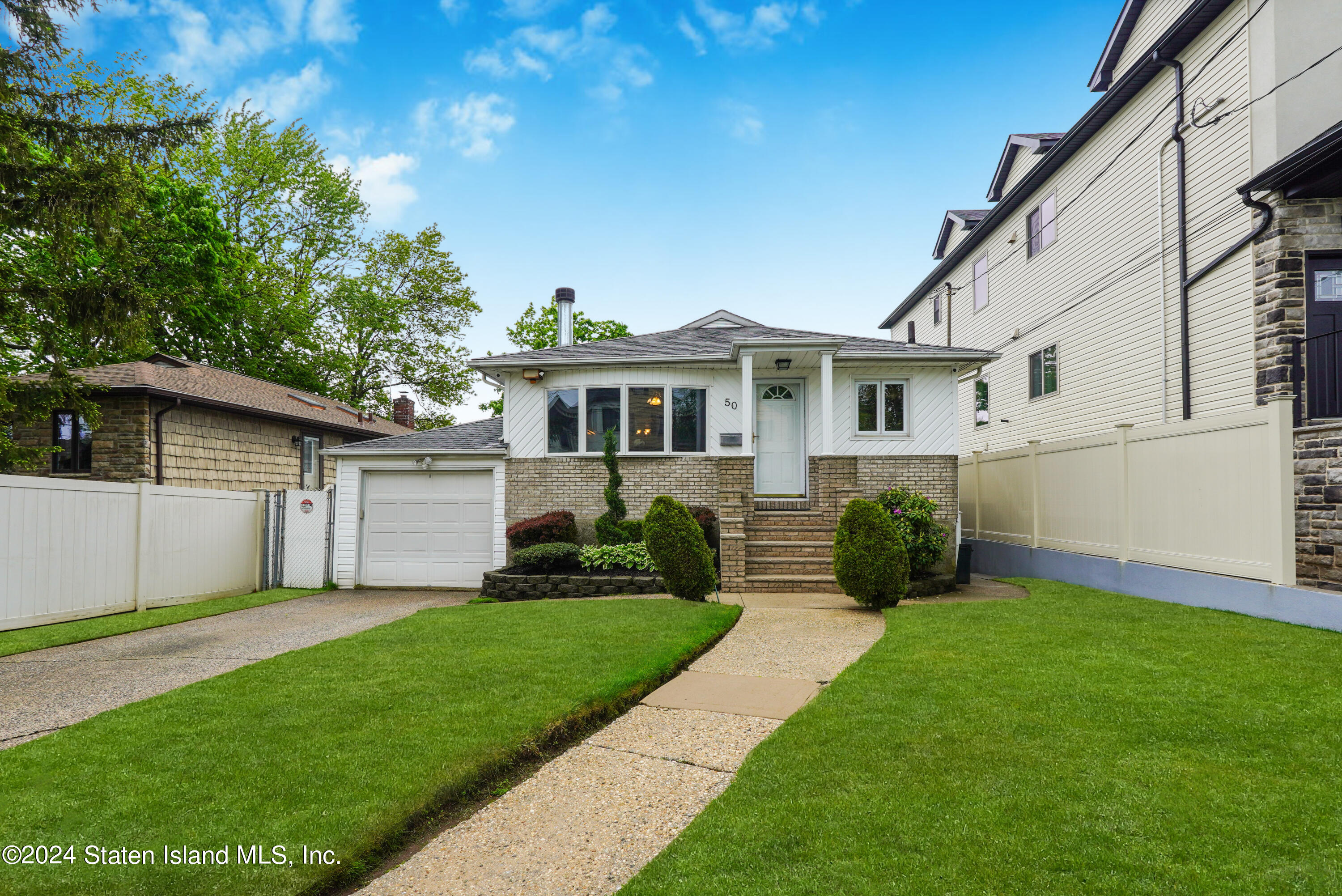 50 Ridgecrest Avenue Staten Island, NY 10312 - Photo 2 of 34 a front view of house with yard and green space