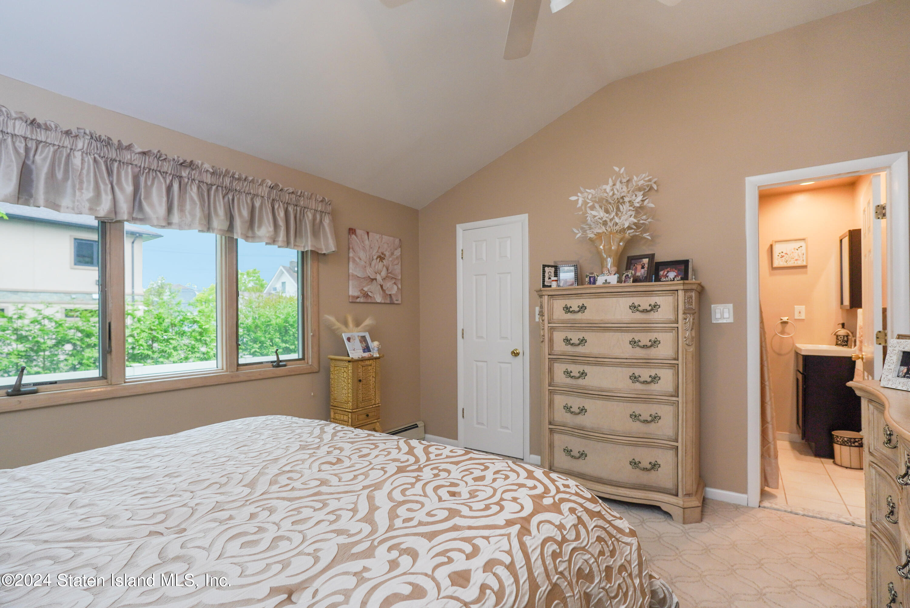 50 Ridgecrest Avenue Staten Island, NY 10312 - Photo 21 of 34 a bedroom with a bed and a dresser