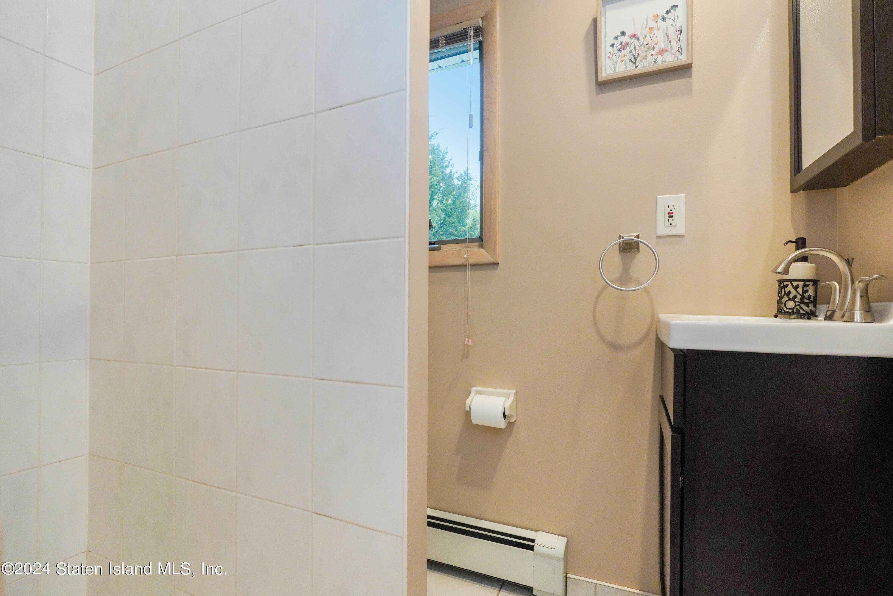 50 Ridgecrest Avenue Staten Island, NY 10312 - Photo 23 of 34 a bathroom with a sink and a mirror